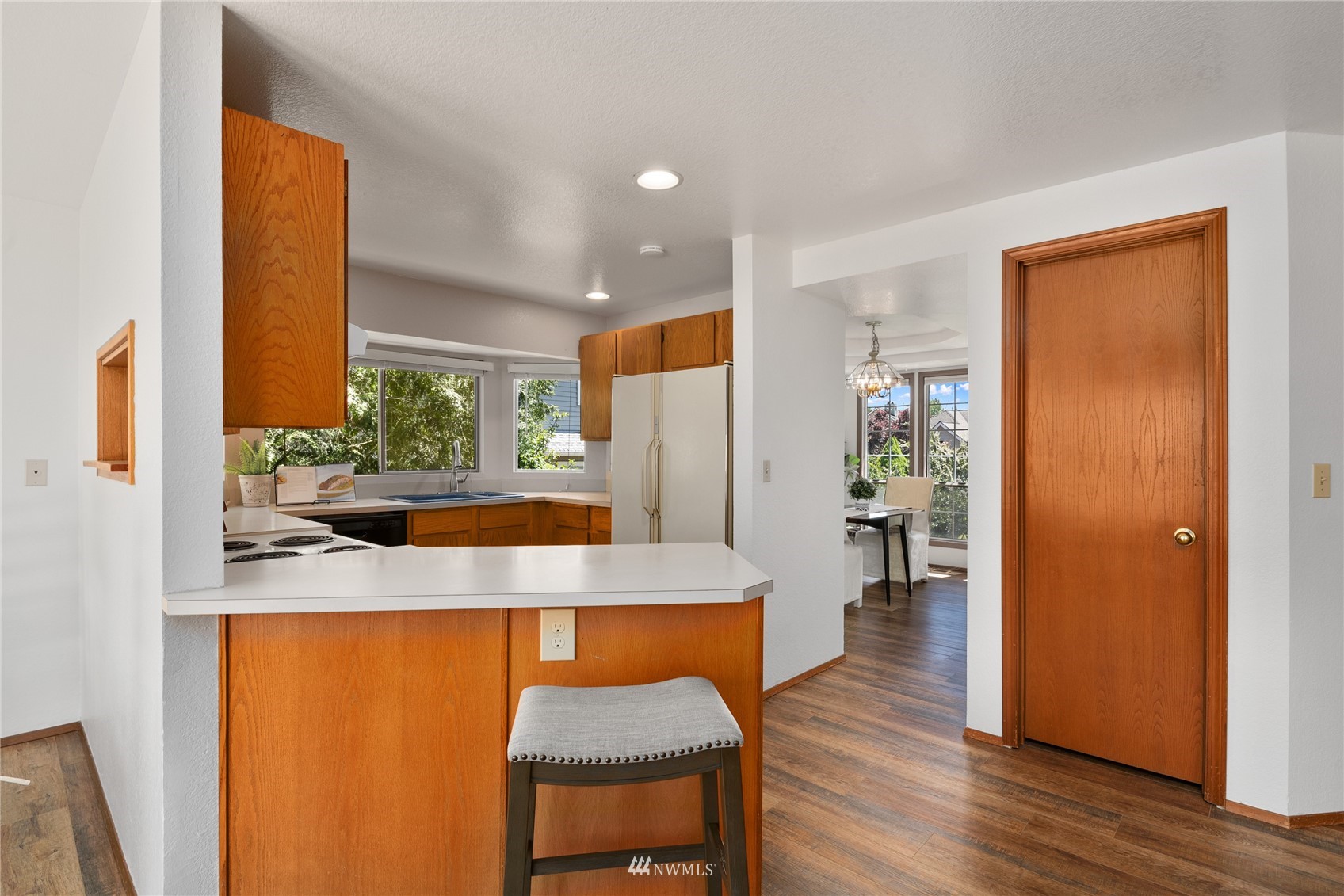 813 226th Street Southeast Bothell, WA 98021 - Photo 9 of 30 a view of a kitchen area with furniture and wooden floor