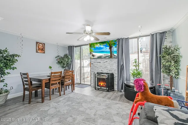a living room with furniture a fireplace and a potted plant