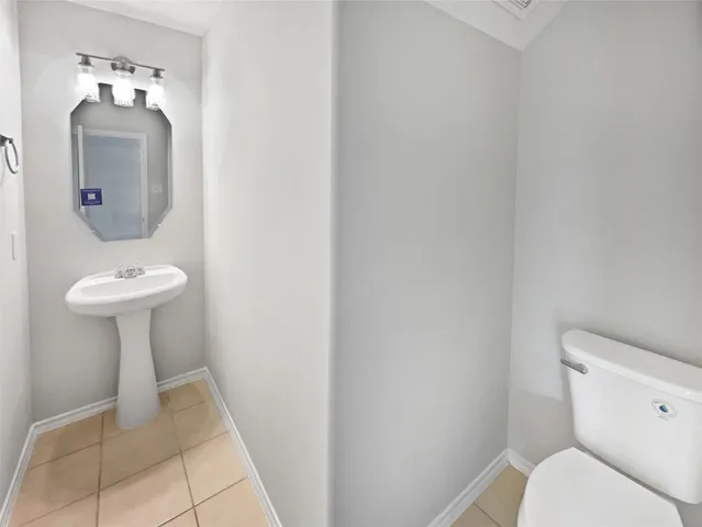 a bathroom with a sink toilet and a mirror