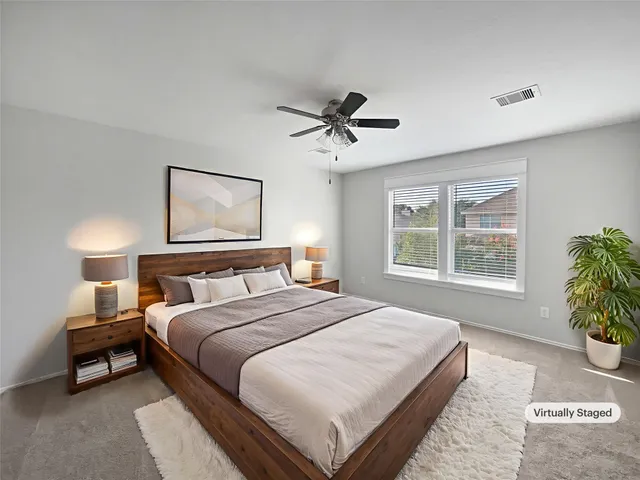 a bedroom with a bed and a window