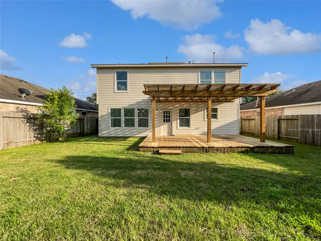 a view of a house with a yard patio and swimming pool
