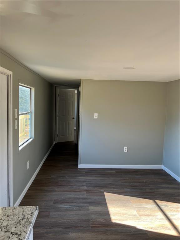338 Georgianna Street Jasper, GA 30143 - Photo 4 of 8 a view of an empty room with wooden floor and a window