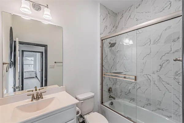 a bathroom with a sink toilet and shower