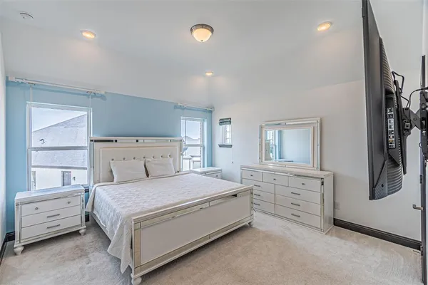 a spacious bedroom with a bed and a window