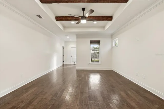 a view of empty room with wooden floor