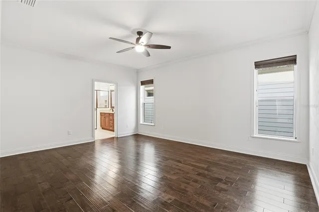 a bathroom with a granite countertop double vanity sink and a mirror