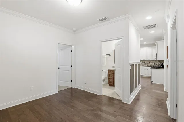 an empty room with windows and cabinet