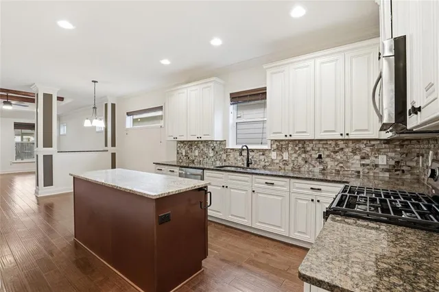 a kitchen with a stove refrigerator and microwave