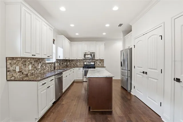 a view of empty room with wooden floor and window