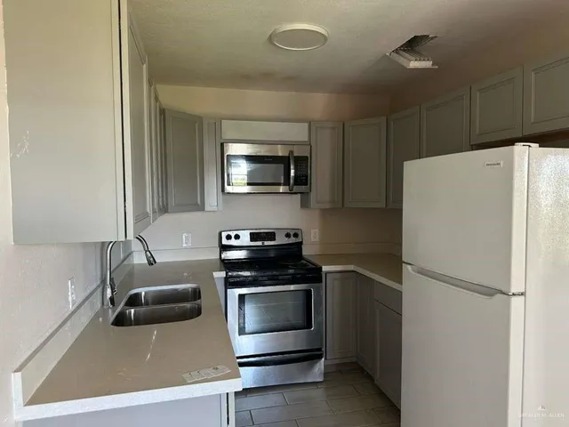 a kitchen with a refrigerator stove and microwave