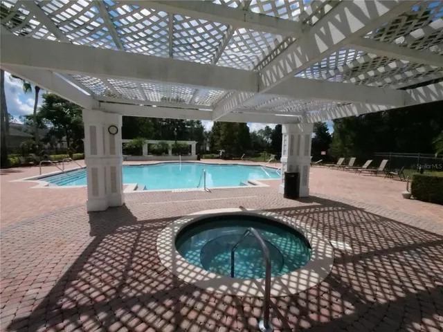 a view of a swimming pool and lounge chair