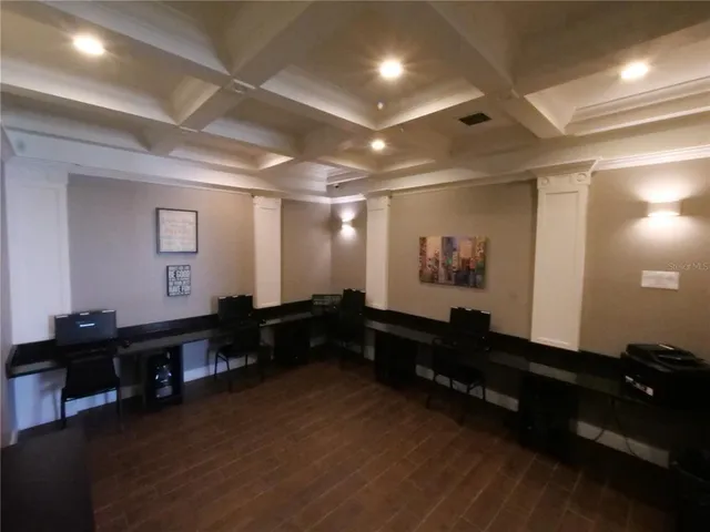 a view of a white house with a yard and potted plants