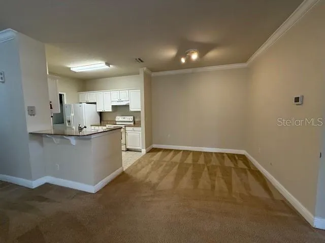 a view of kitchen with refrigerator sink and microwave