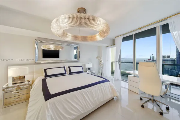 a bedroom with a bed and a view of kitchen