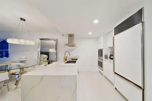 a kitchen with stainless steel appliances a sink stove and refrigerator