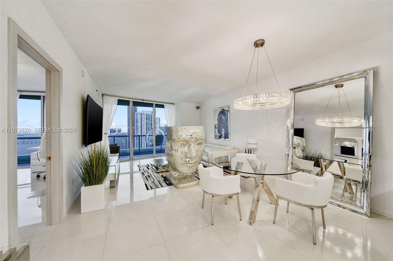 495 Brickell Avenue, Unit 4209 Miami, FL 33131 - Photo 5 of 37 a living room with furniture dining table and a chandelier