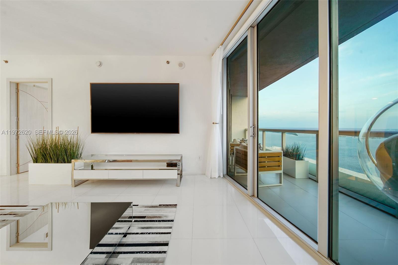495 Brickell Avenue, Unit 4209 Miami, FL 33131 - Photo 9 of 37 a living room with furniture and a flat screen tv