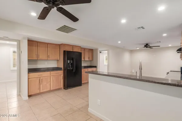 a kitchen with a refrigerator and a sink