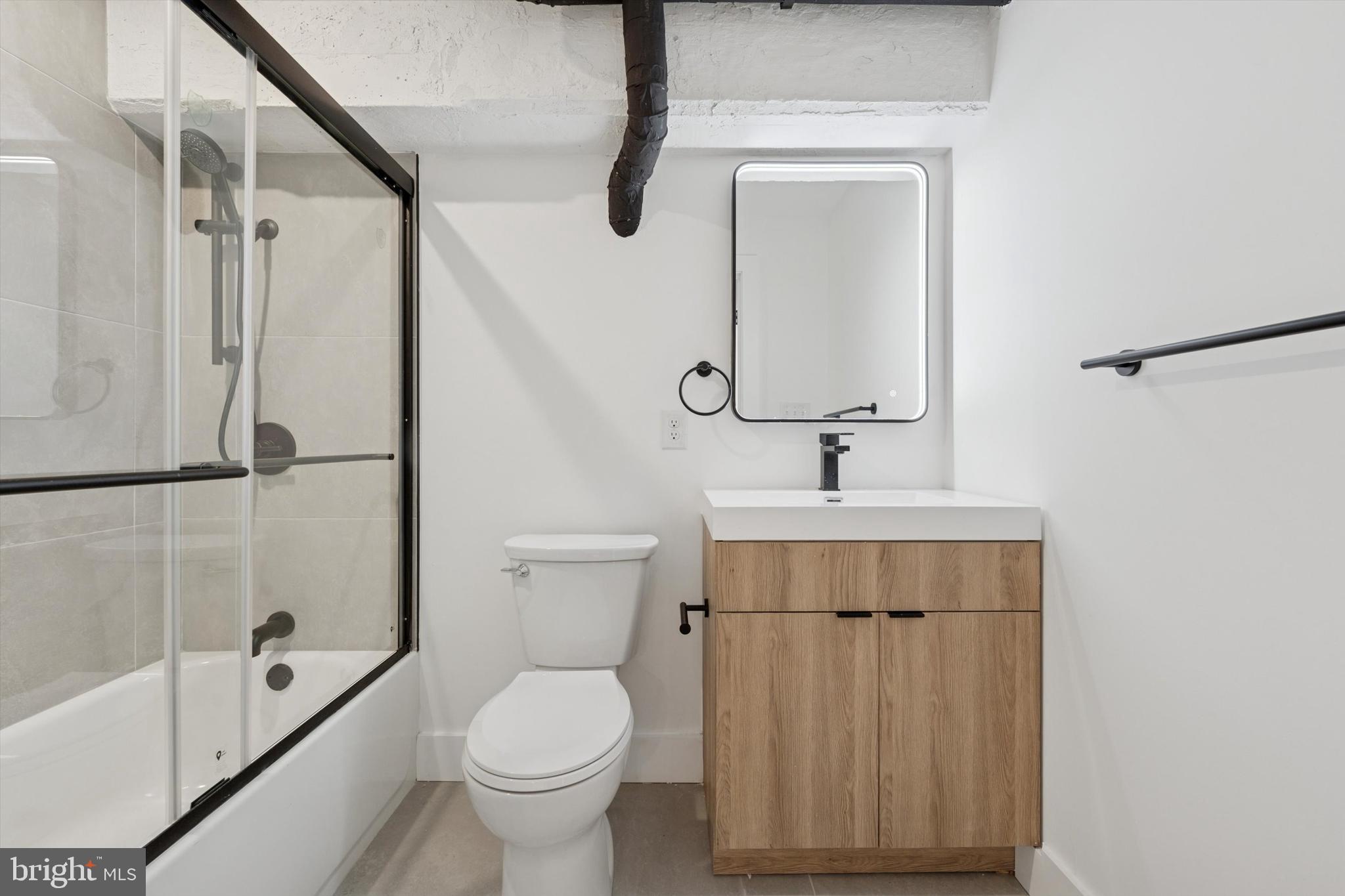 538 Federal Street, Unit 104 Philadelphia, PA 19147 - Photo 14 of 27 a bathroom with a toilet sink and a shower