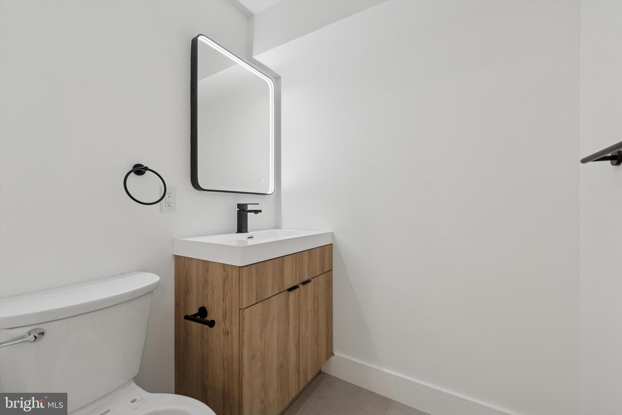538 Federal Street, Unit 104 Philadelphia, PA 19147 - Photo 16 of 27 a bathroom with a sink toilet and mirror