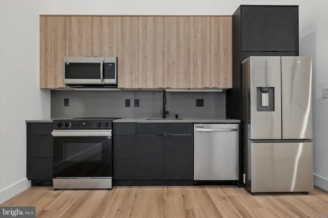 a kitchen with a sink and a refrigerator