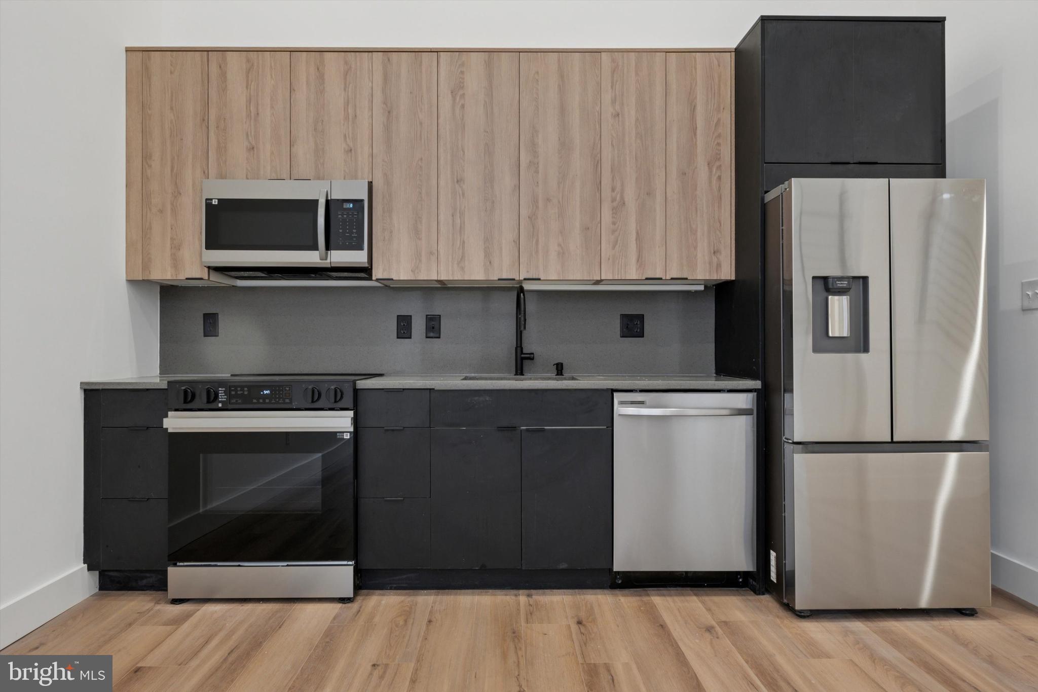 538 Federal Street, Unit 104 Philadelphia, PA 19147 - Photo 2 of 27 a kitchen with a sink and a refrigerator