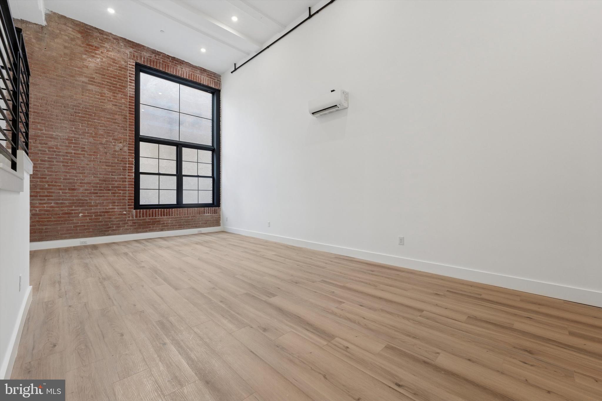 538 Federal Street, Unit 104 Philadelphia, PA 19147 - Photo 3 of 27 a view of an empty room with wooden floor and a window