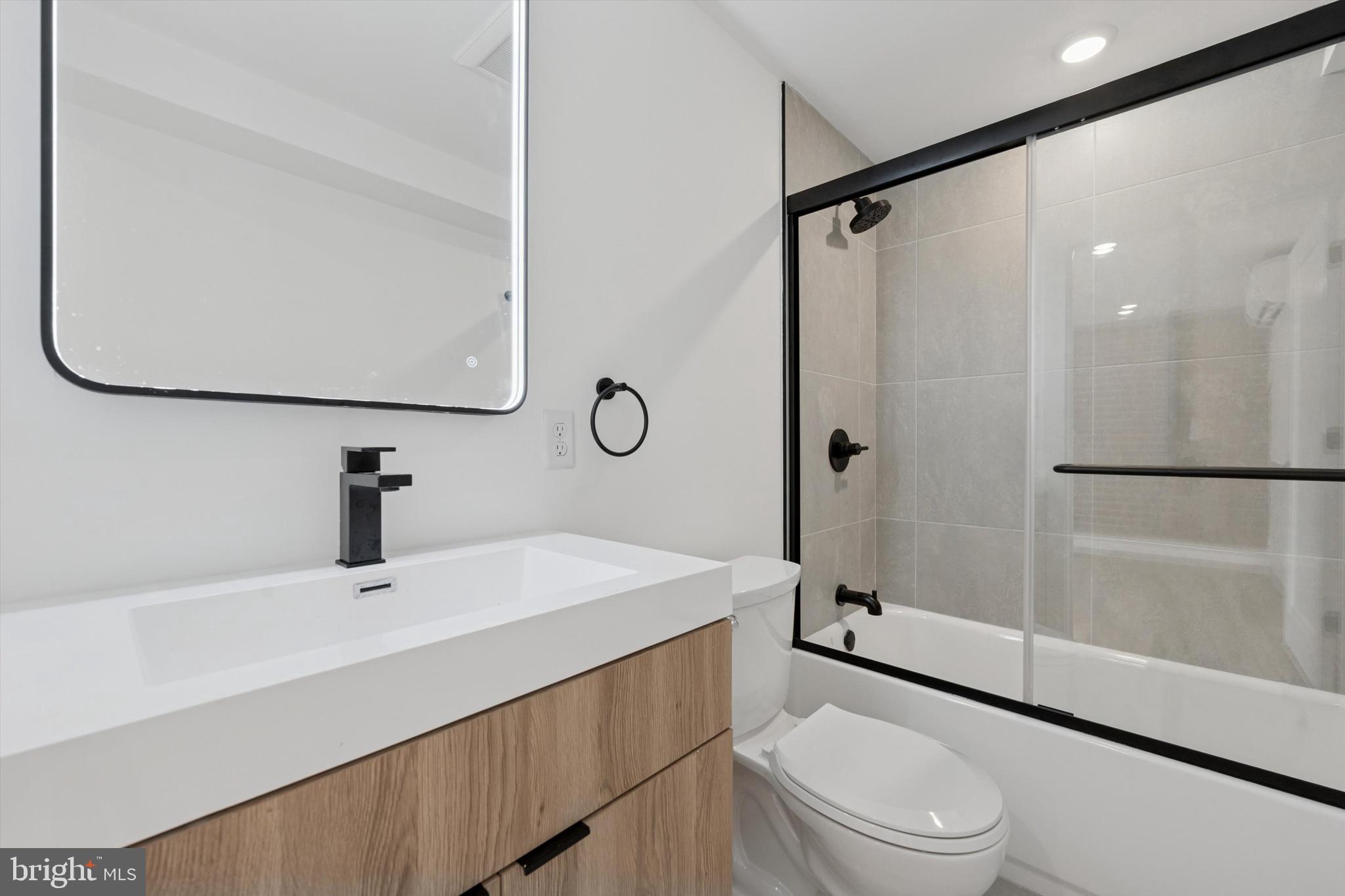 538 Federal Street, Unit 104 Philadelphia, PA 19147 - Photo 6 of 27 a bathroom with a sink a toilet and shower