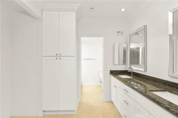 a spacious bathroom with a granite countertop sink and a mirror