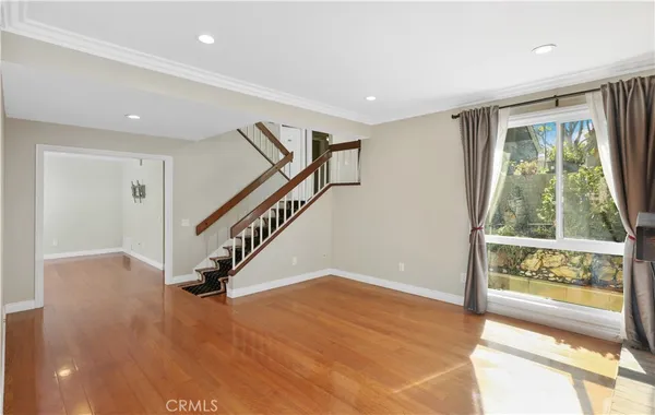 a view of entryway with wooden floor and windows