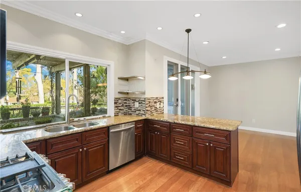 a large kitchen with a large window and stainless steel appliances