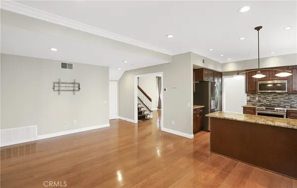 a view of a kitchen with furniture and a ceiling fan