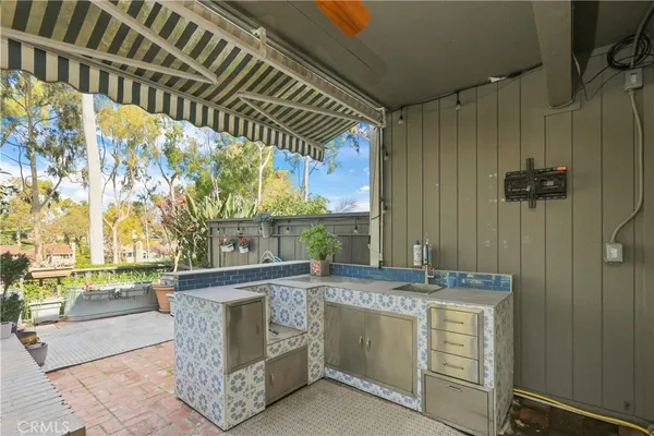 a view of a kitchen with a sink and wooden floor