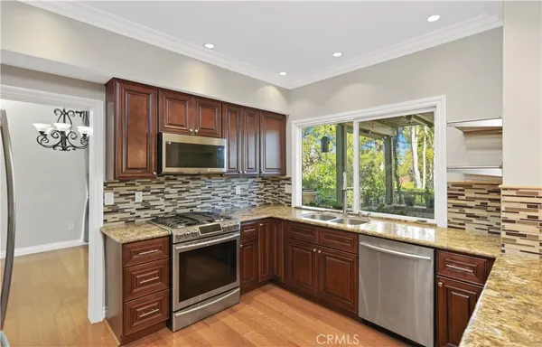 a kitchen with stainless steel appliances granite countertop a stove and a sink