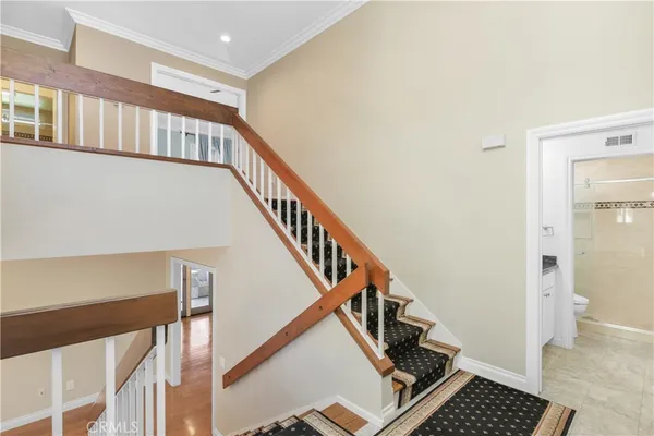 a view of staircase with wooden floor and a potted plant