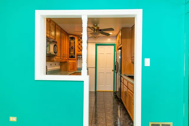 a kitchen with stainless steel appliances granite countertop a refrigerator and a sink