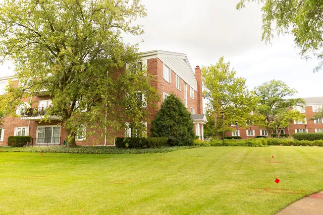 a view of a building with trees in front of it