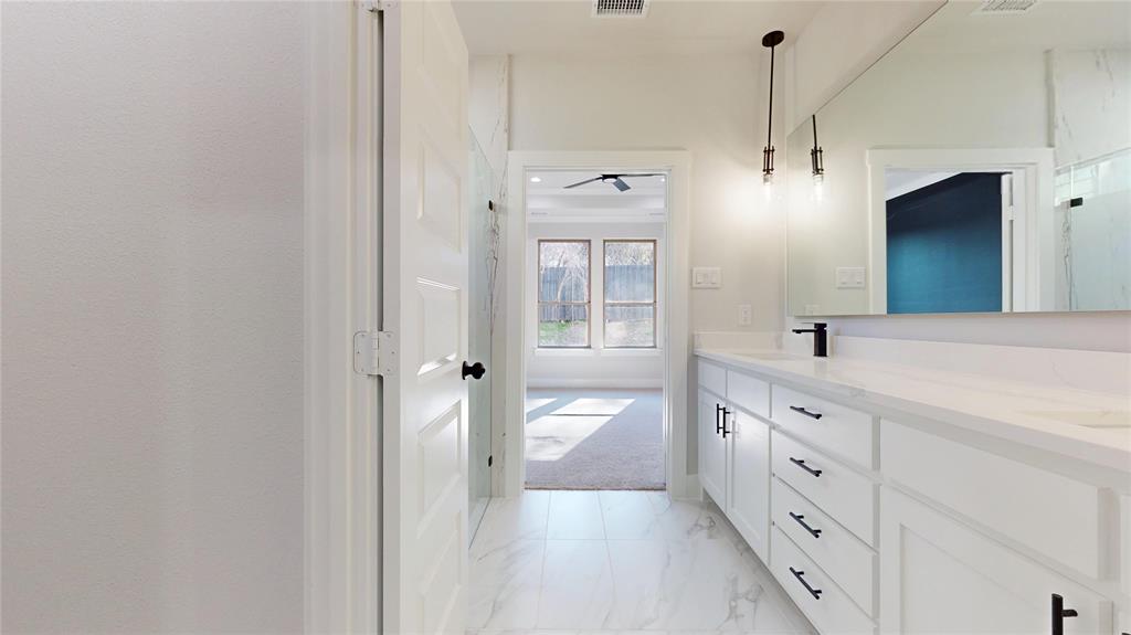 801 Birch Street Grand Prairie, TX 75050 - Photo 18 of 28 a spacious bathroom with a granite countertop sink mirror and a bathtub