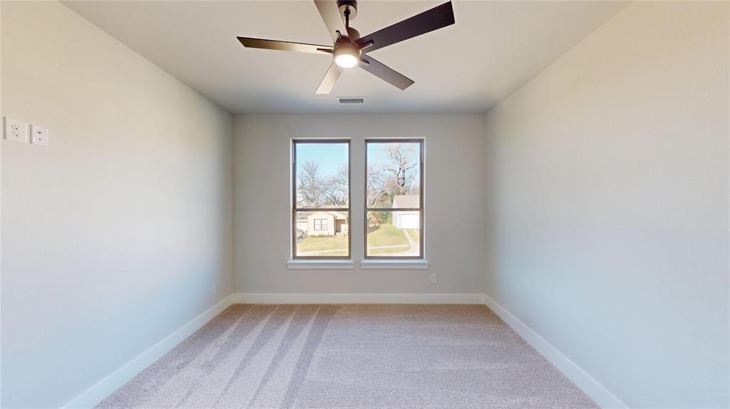 801 Birch Street Grand Prairie, TX 75050 - Photo 21 of 28 an empty room with a window and a fan
