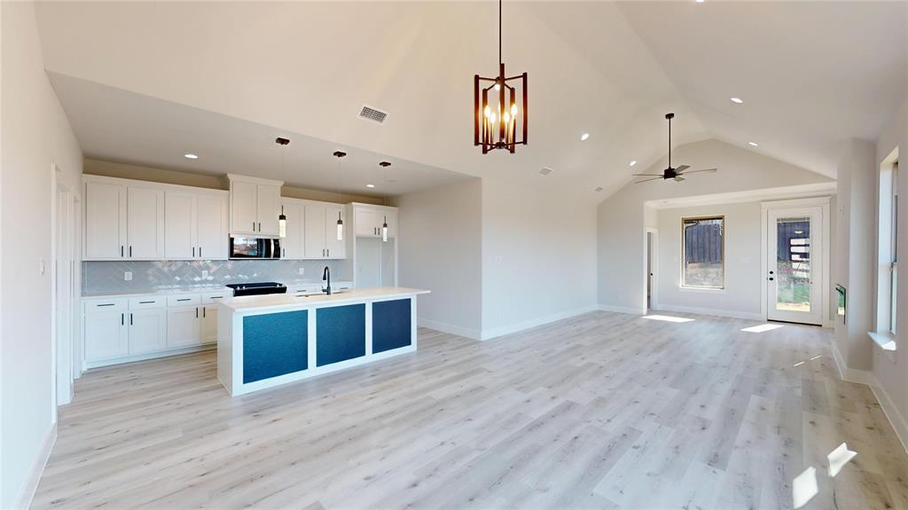 801 Birch Street Grand Prairie, TX 75050 - Photo 4 of 28 a large kitchen with kitchen island a sink stainless steel appliances and cabinets