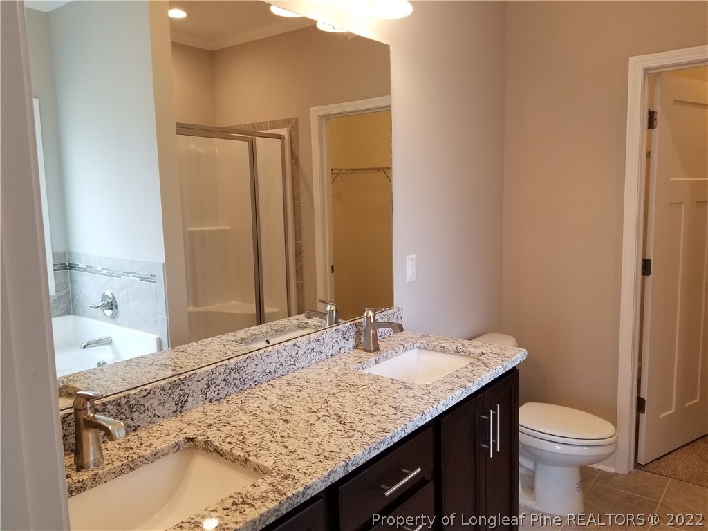5224-lot7 J T Matthews Road Godwin, NC 28344 - Photo 23 of 42 a bathroom with a granite countertop sink a toilet and shower