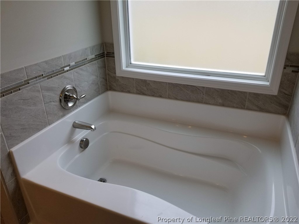 5224-lot7 J T Matthews Road Godwin, NC 28344 - Photo 25 of 42 a bathroom with a tub
