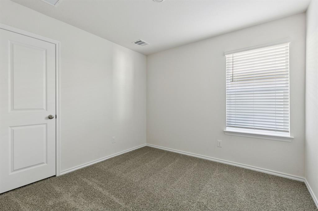 317 Clematis Street Princeton, TX 75407 - Photo 22 of 38 Carpeted empty room featuring baseboards