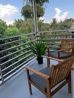 a view of a balcony with table and chairs
