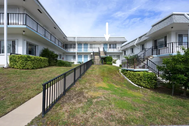 a view of a brick house with a yard