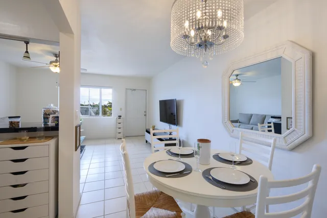 a kitchen with furniture and a chandelier