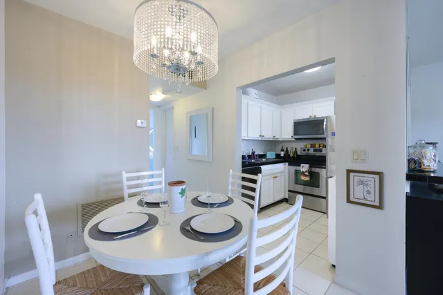a view of a dining room with furniture and chandelier