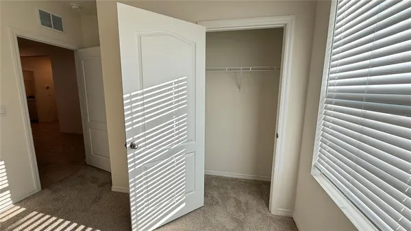 a view of a room with wooden floor and cabinet
