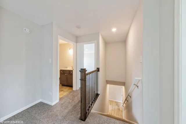 a view of a hallway with closet and wooden floor