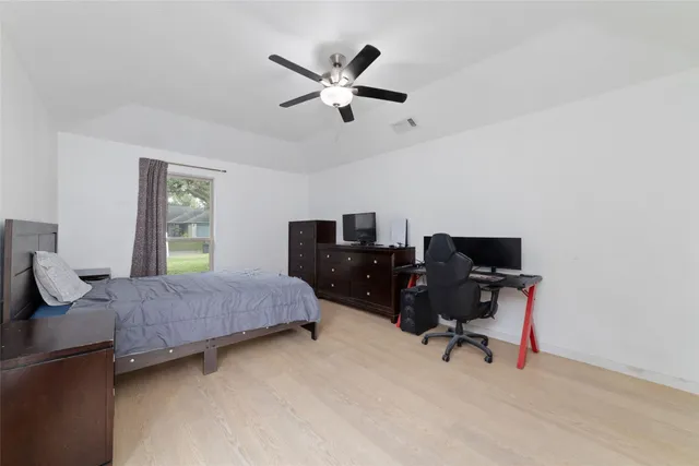 a bedroom with a workspace